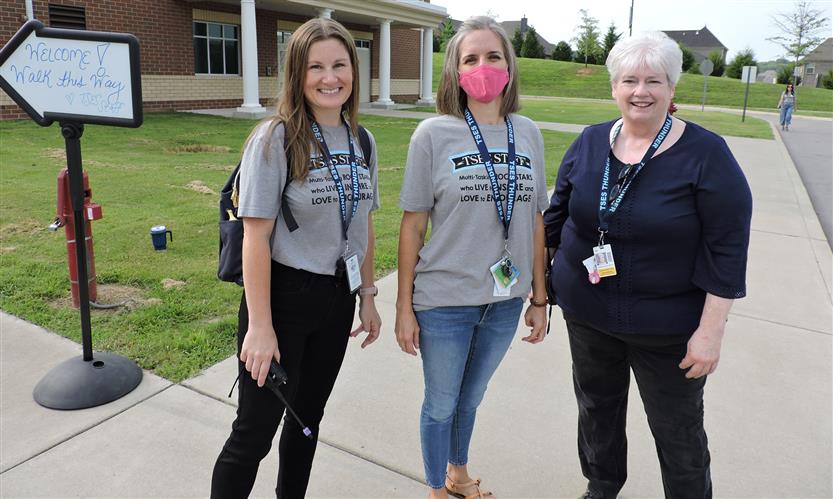 A group of teachers smiles